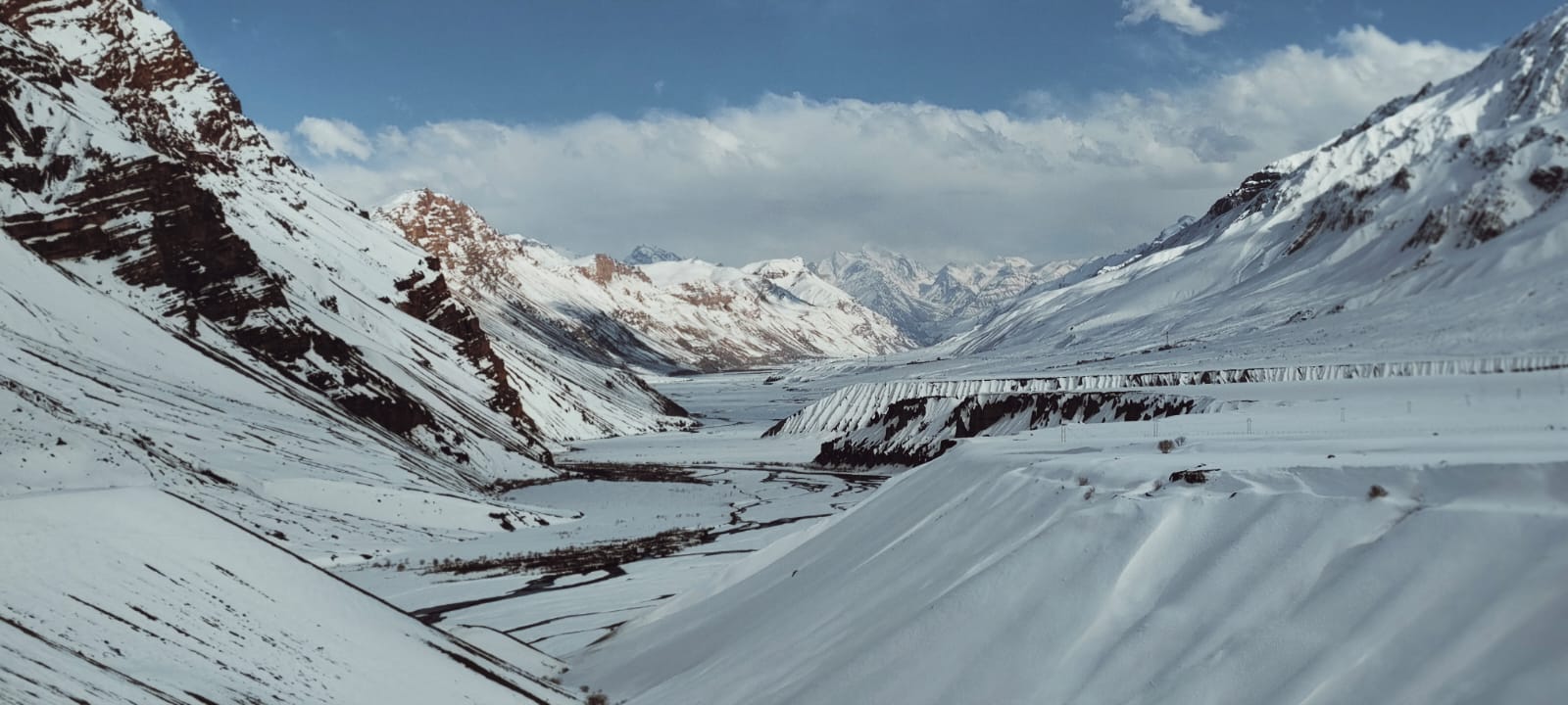 4x4 with chains fitted on a snow-packed mountain road